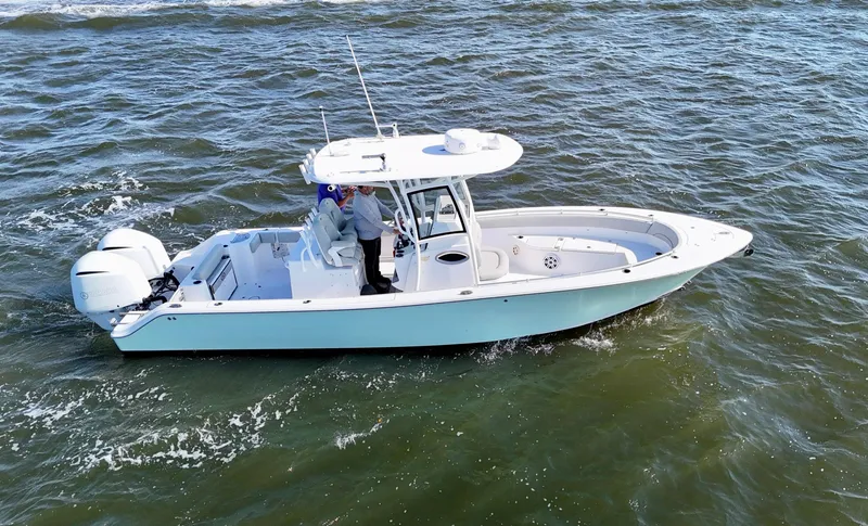 Slide: The Image of 2020 Sportsman Open 282 Center Console boat cruising on open water. - 7