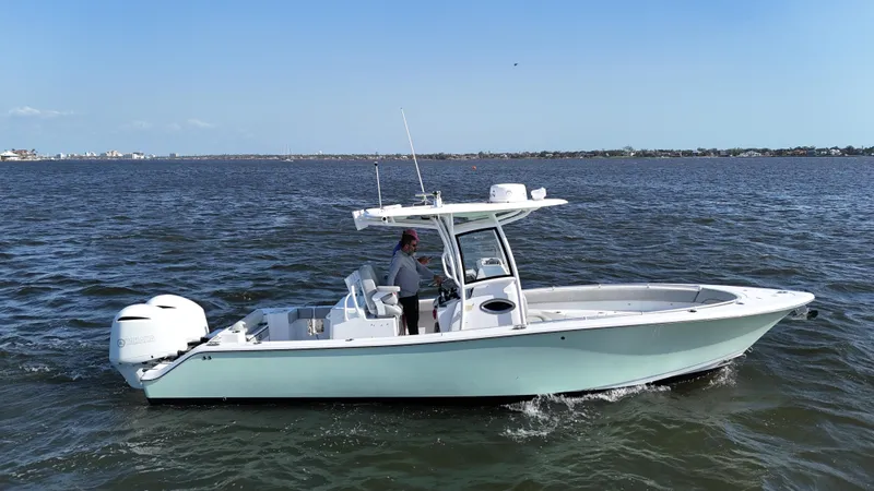 Slide: The Image of 2020 Sportsman Open 282 Center Console boat cruising on open water. - 9