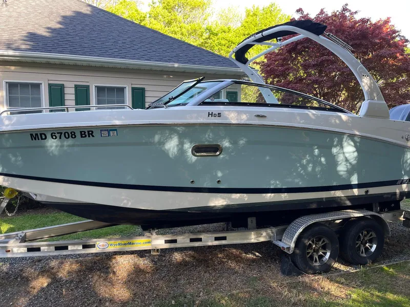 The Image of 2022 Four Winns HD5 OB boat on trailer, parked beside a house. - 0