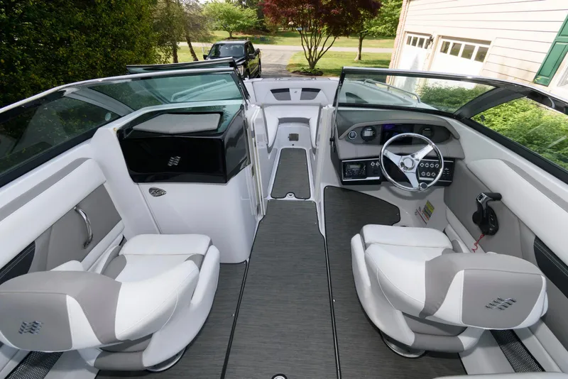 Slide: The Image of 2022 Four Winns HD5 OB boat interior with modern seating and steering wheel. - 8