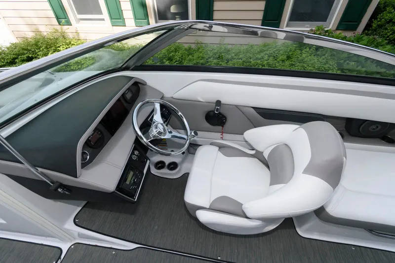 Slide: The Image of 2022 Four Winns HD5 OB boat interior with sleek steering and modern seating design. - 9