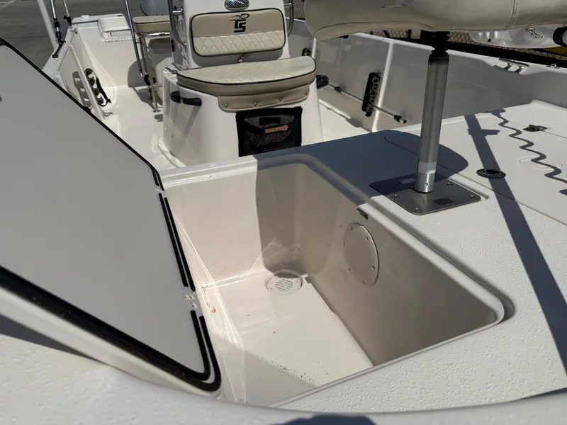 Slide: The Image of 2021 Carolina Skiff 192 JLS boat interior with open storage compartment. - 11