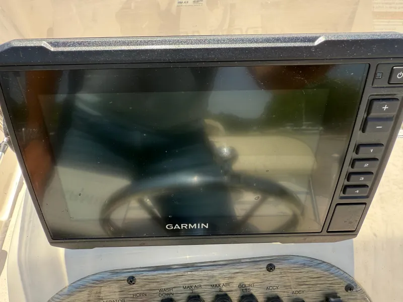 Slide: The Image of Garmin display on 2021 Carolina Skiff 192 JLS boat dashboard, showing control buttons. - 20