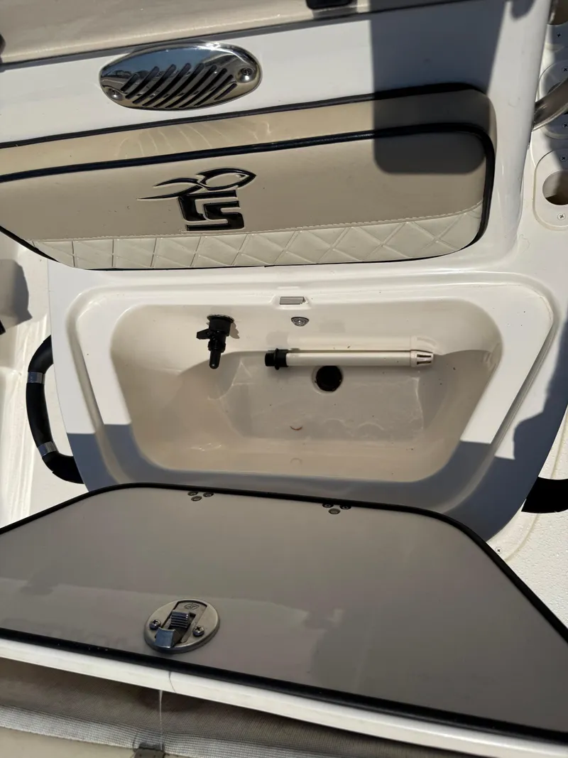 Slide: The Image of 2021 Carolina Skiff 192 JLS boat storage compartment with open hatch. - 21
