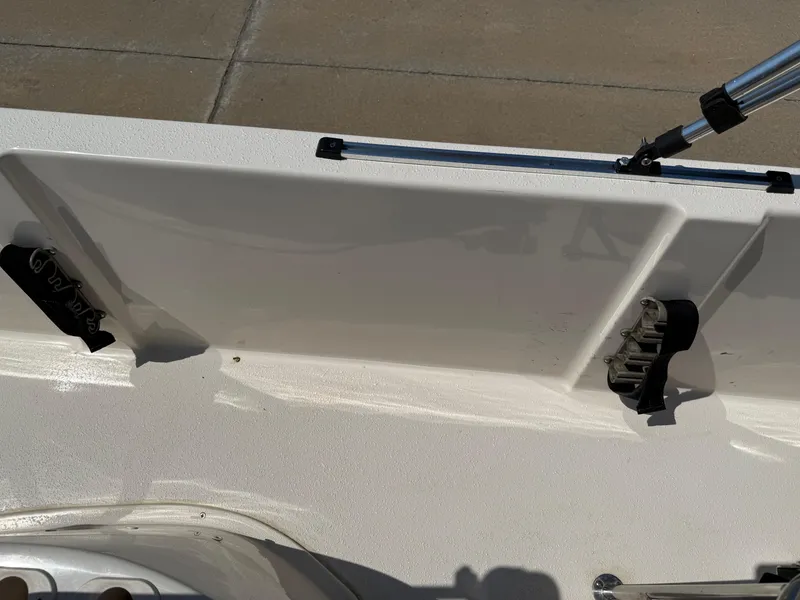 Slide: The Image of 2021 Carolina Skiff 192 JLS boat interior with rod holders and clean white finish. - 24