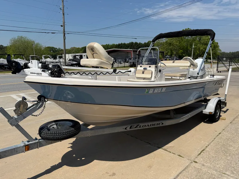 Slide: The Image of 2021 Carolina Skiff 192 JLS boat on trailer, parked outdoors under clear sky. - 4