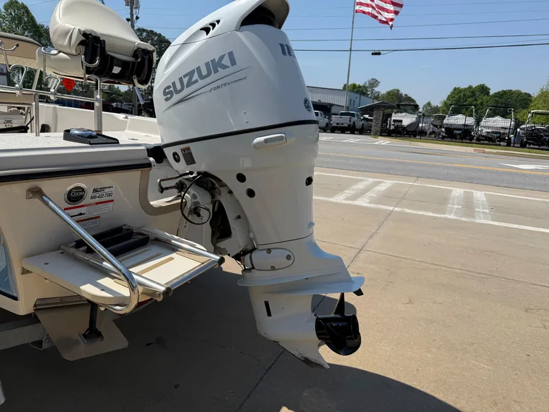 Slide: The Image of 2021 Carolina Skiff 192 JLS with Suzuki outboard motor, parked on a sunny day. - 6