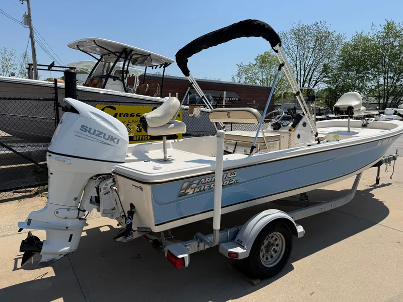 Slide: The Image of 2021 Carolina Skiff 192 JLS boat with Suzuki outboard motor on a trailer. - 8