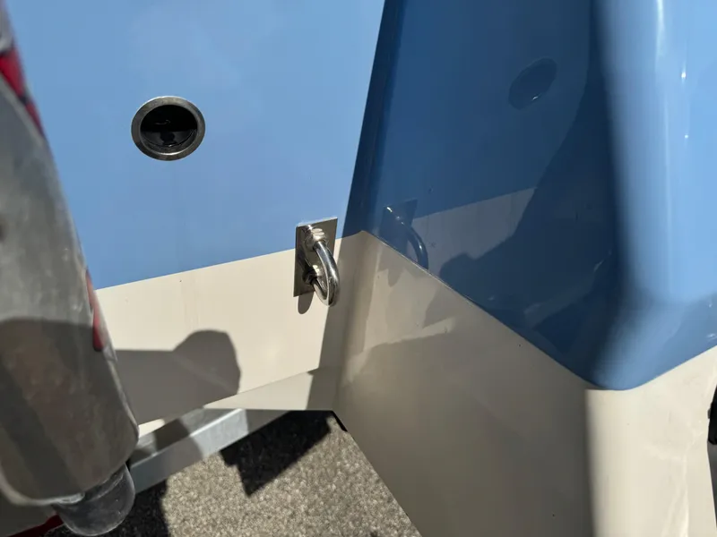 Slide: The Image of 2023 Robalo 246 Cayman boat detail, featuring blue and white hull design. - 11