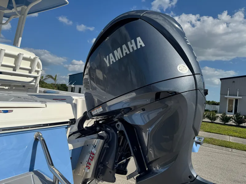 Slide: The Image of 2023 Robalo 246 Cayman with Yamaha outboard motor under a clear blue sky. - 14