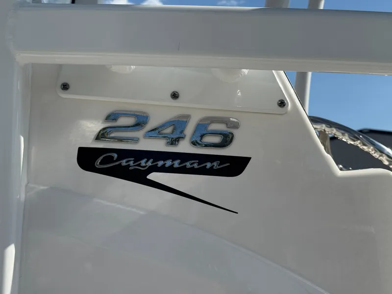 Slide: The Image of 2023 Robalo 246 Cayman boat logo on white surface under blue sky. - 18