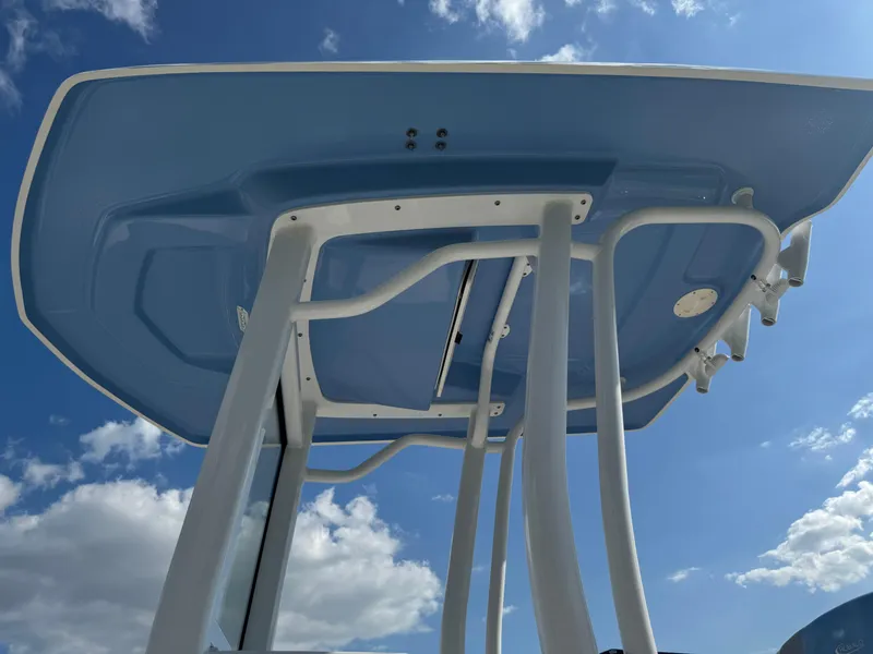 Slide: The Image of 2023 Robalo 246 Cayman boat T-top against a blue sky. - 19
