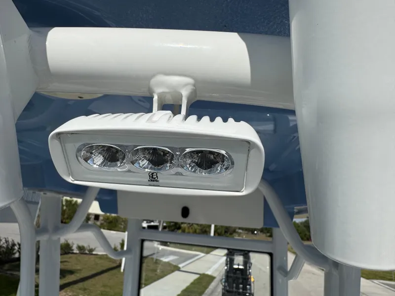 Slide: The Image of LED light fixture on 2023 Robalo 246 Cayman boat, mounted on white frame. - 28