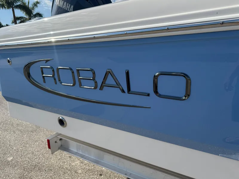 Slide: The Image of 2023 Robalo 246 Cayman boat with logo, featuring sleek design and blue exterior. - 3