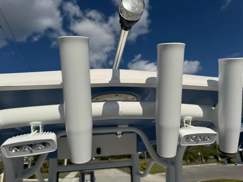 Slide: The Image of 2023 Robalo 246 Cayman boat with rod holders and LED lights under a clear sky. - 30