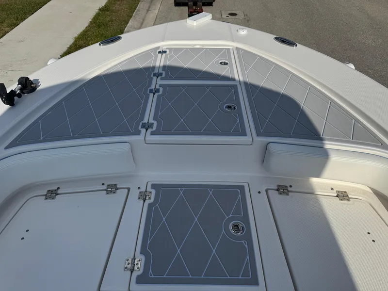 Slide: The Image of 2023 Robalo 246 Cayman boat deck with storage compartments and sleek design. - 32