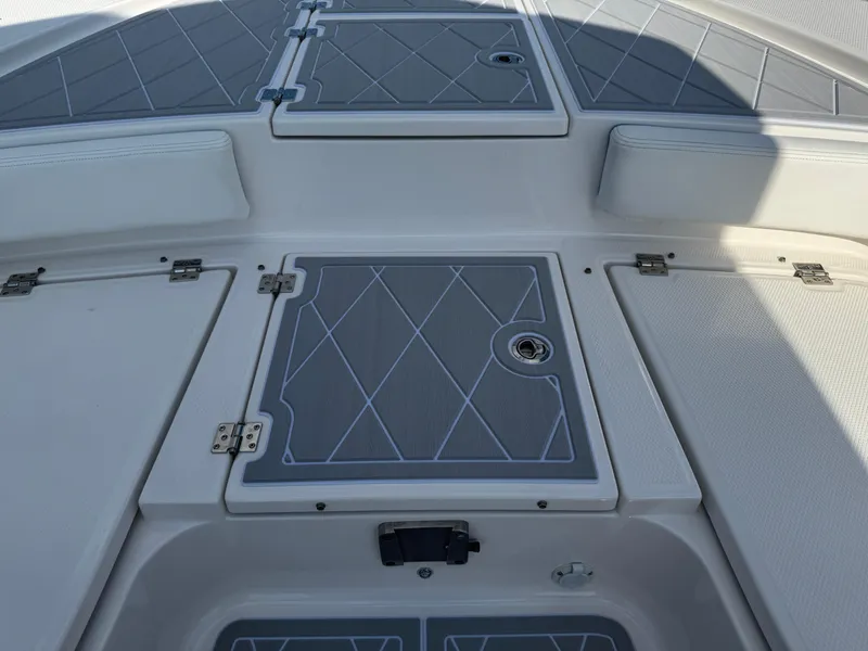 Slide: The Image of 2023 Robalo 246 Cayman boat deck with storage compartments and sleek design. - 33