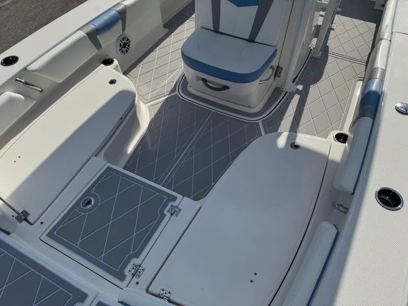 Slide: The Image of 2023 Robalo 246 Cayman boat interior with cushioned seating and non-slip flooring. - 40