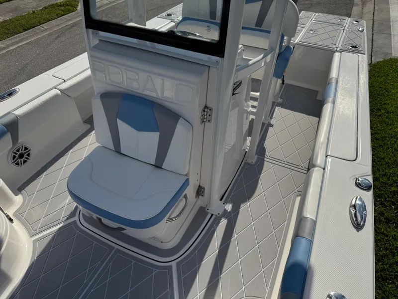 Slide: The Image of 2023 Robalo 246 Cayman boat interior with blue and white seating and sleek design. - 41