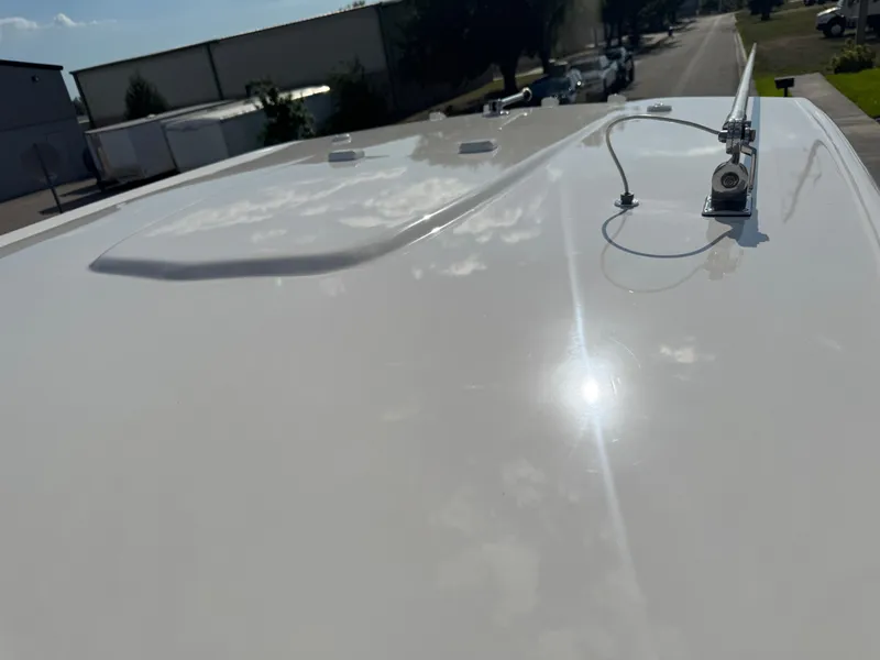Slide: The Image of 2023 Robalo 246 Cayman boat roof with antenna, reflecting sunlight. - 42