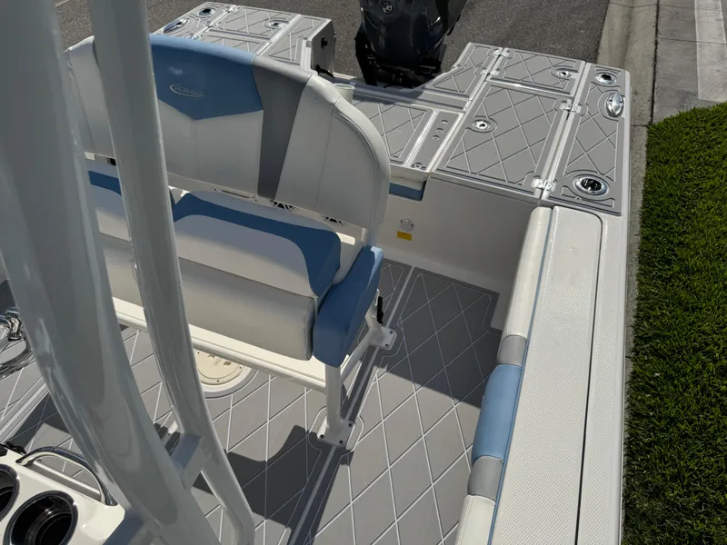 Slide: The Image of 2023 Robalo 246 Cayman boat interior with cushioned seating and storage compartments. - 45