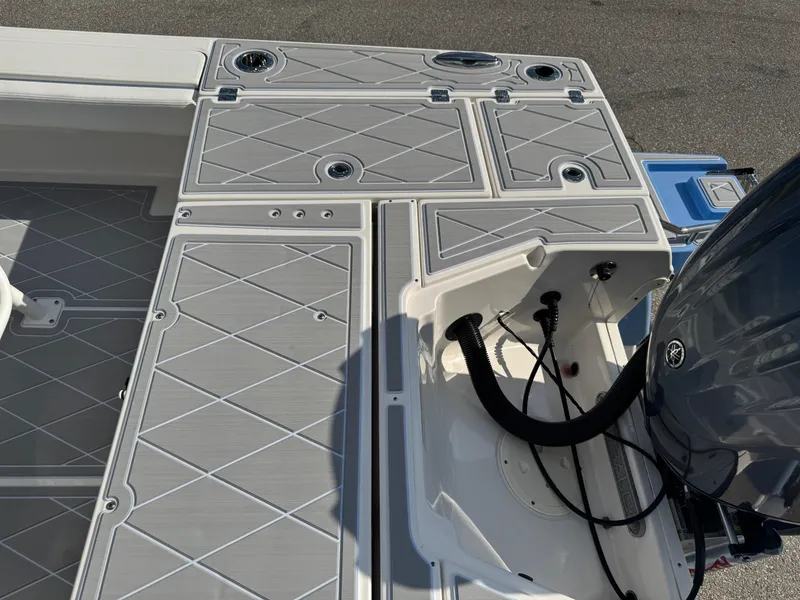 Slide: The Image of 2023 Robalo 246 Cayman boat deck with storage compartments and engine connections. - 47