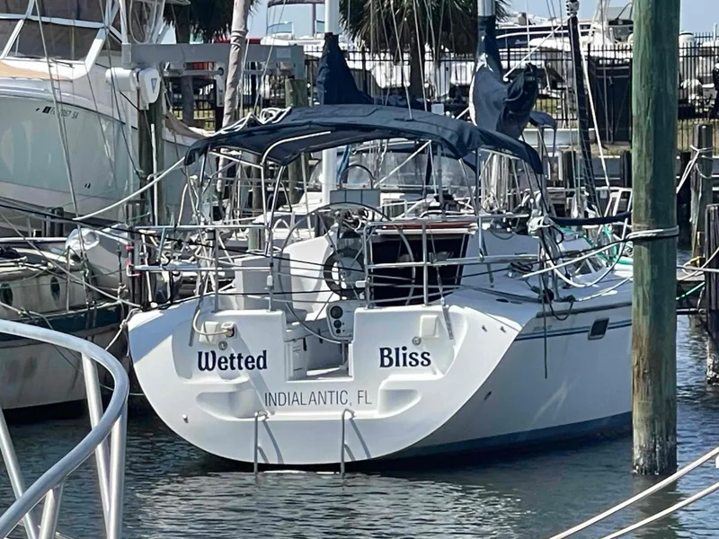 Slide: The Image of Catalina 320 sailboat named "Wetted Bliss" docked in Indialantic, Florida, 1997 model. - 1