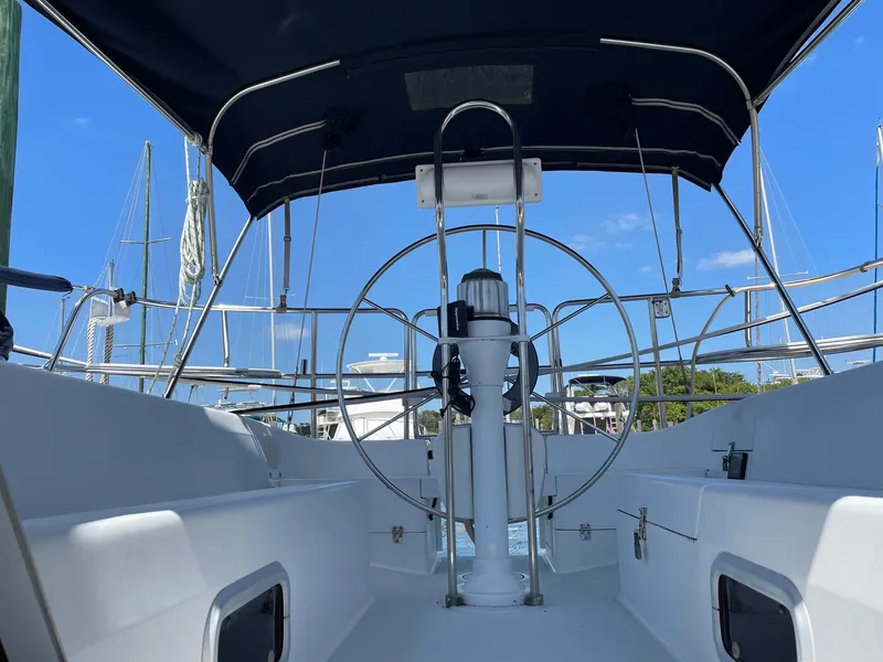 Slide: The Image of Cockpit view of 1997 Catalina 320 sailboat with steering wheel and canopy. - 12