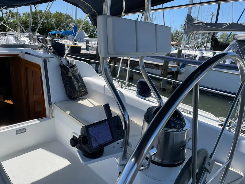 Slide: The Image of Cockpit of a 1997 Catalina 320 sailboat with navigation equipment and seating. - 15