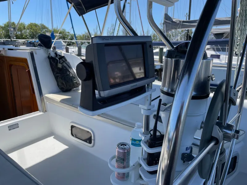 Slide: The Image of Cockpit of 1997 Catalina 320 sailboat with navigation equipment and drink holders. - 16