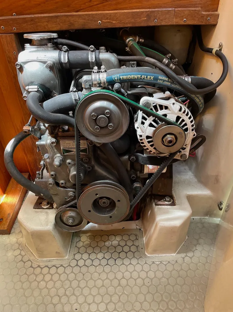 Slide: The Image of Catalina 320 1997 engine compartment with visible belts and hoses. - 33