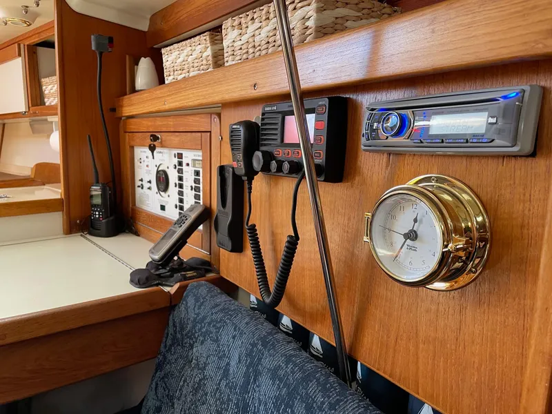 Slide: The Image of 1997 Catalina 320 yacht interior with navigation equipment and wooden paneling. - 34