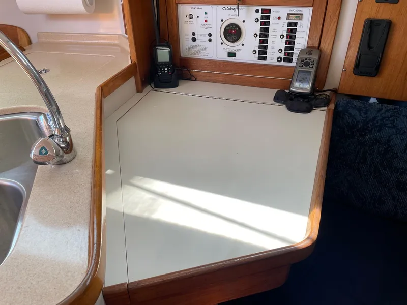 Slide: The Image of Interior of a 1997 Catalina 320 sailboat with navigation panel and sink. - 35