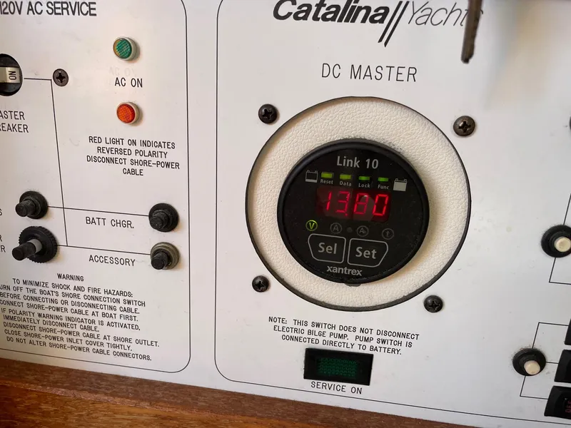 Slide: The Image of Control panel of a 1997 Catalina 320 yacht with digital display and switches. - 36