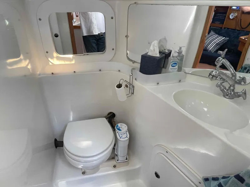 Slide: The Image of Bathroom interior of a 1997 Catalina 320 yacht, featuring a toilet and sink. - 7