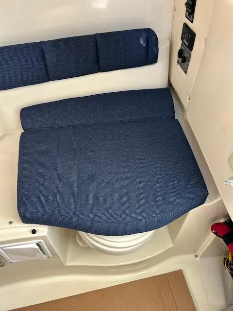 Slide: The Image of 2006 Wellcraft 252 Coastal boat interior with blue cushioned seating. - 10