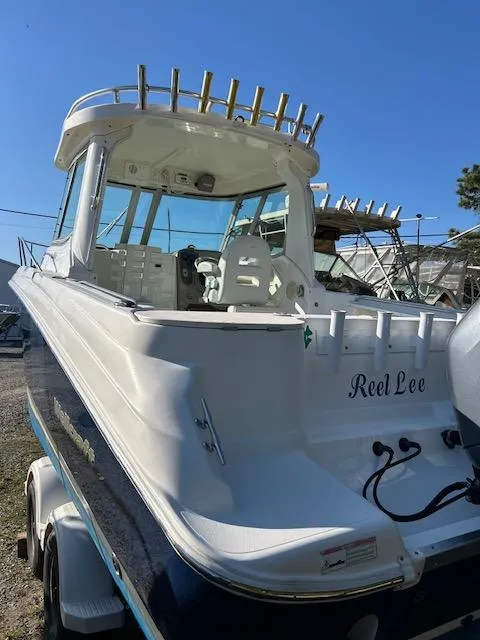 Slide: The Image of 2006 Wellcraft 252 Coastal boat, white exterior, docked, sunny day. - 14