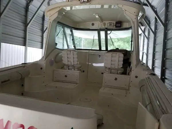 Slide: The Image of 2006 Wellcraft 252 Coastal boat interior with seating, stored in a covered area. - 2