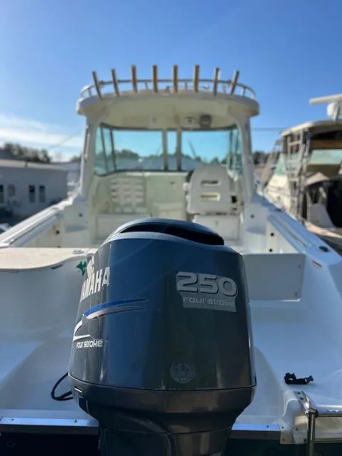Slide: The Image of 2006 Wellcraft 252 Coastal boat with Yamaha 250 four-stroke engine, docked under clear skies. - 5