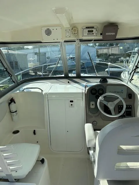 Slide: The Image of 2006 Wellcraft 252 Coastal boat interior with steering wheel and Garmin navigation system. - 8