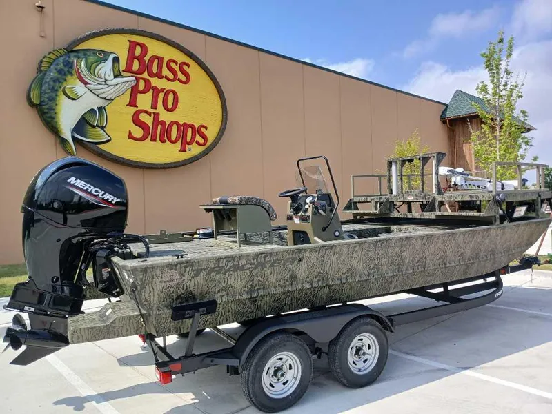 Slide: The Image of 2025 Tracker Grizzly 2072 CC Sportsman boat outside Bass Pro Shops on a trailer. - 3