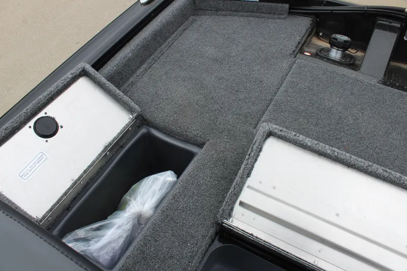 Slide: The Image of 2025 Tracker Pro Team 175 boat interior with storage compartments and carpeted flooring. - 14