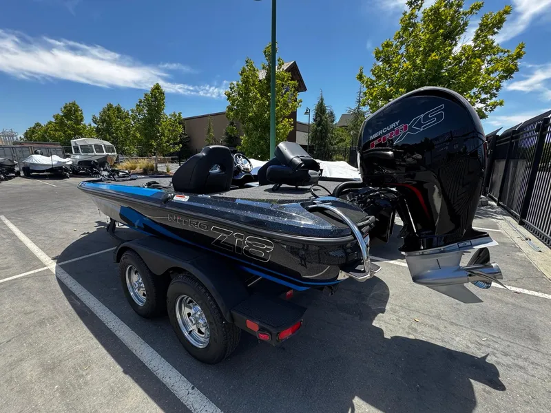 Slide: The Image of 2025 Nitro Z18 Pro boat with Mercury engine in a parking lot. - 3