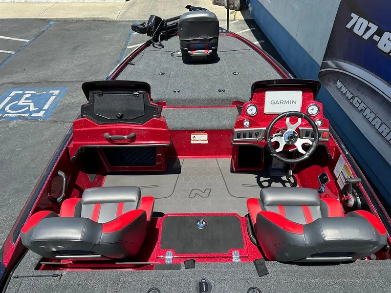 Slide: The Image of 2025 Nitro Z19 Pro boat interior with red and gray seats, Garmin dashboard, and steering wheel. - 11