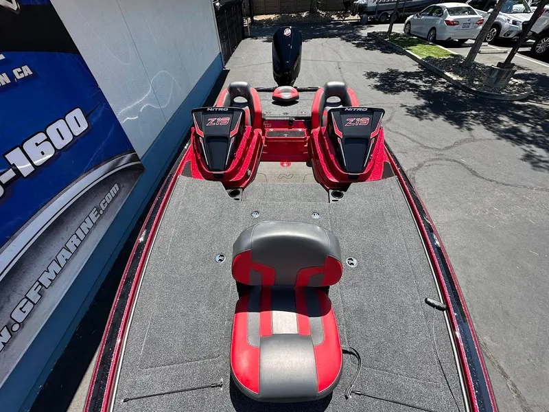 Slide: The Image of 2025 Nitro Z19 Pro boat with red and black seating, parked outdoors. - 26