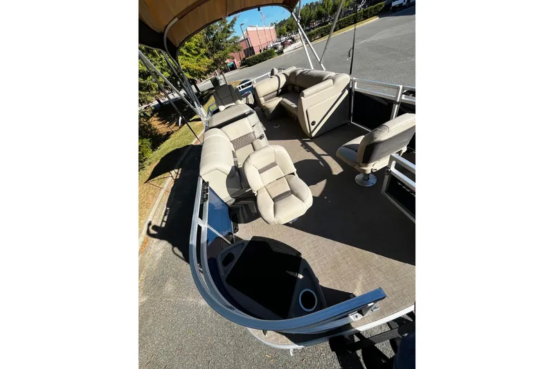 Slide: The Image of 2025 Sun Tracker Fishin' Barge 20 DLX with spacious seating and canopy. - 4