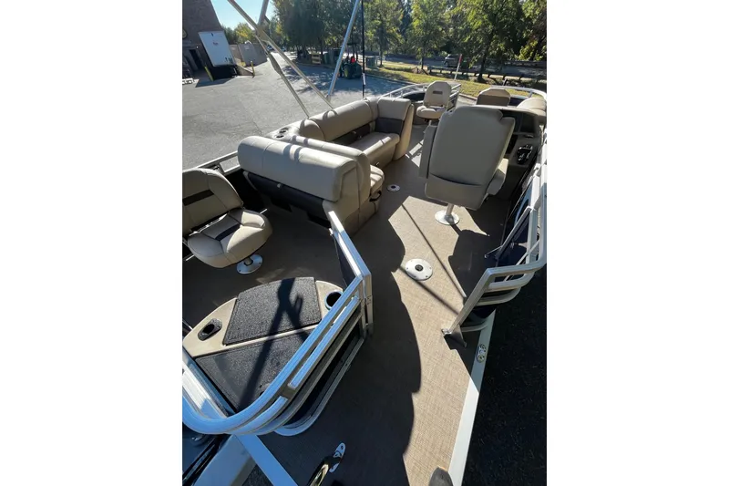 Slide: The Image of 2025 Sun Tracker Fishin' Barge 20 DLX interior with seating and fishing amenities. - 6
