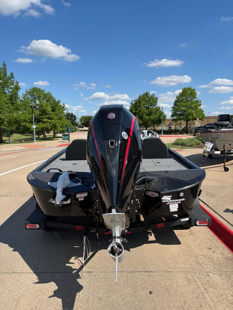 Slide: The Image of 2025 Tracker Savage 215 boat interior with steering console and carpeted deck. - 3