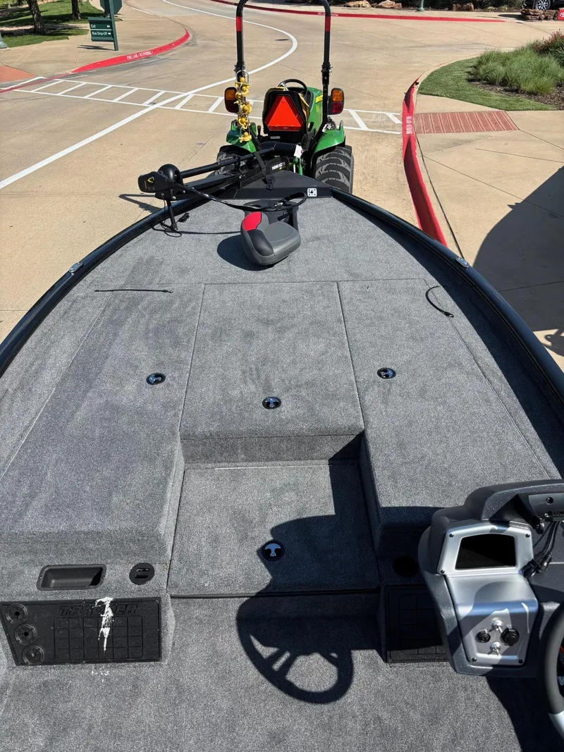 Slide: The Image of 2025 Tracker Savage 215 boat dashboard with steering wheel and control panel. - 4