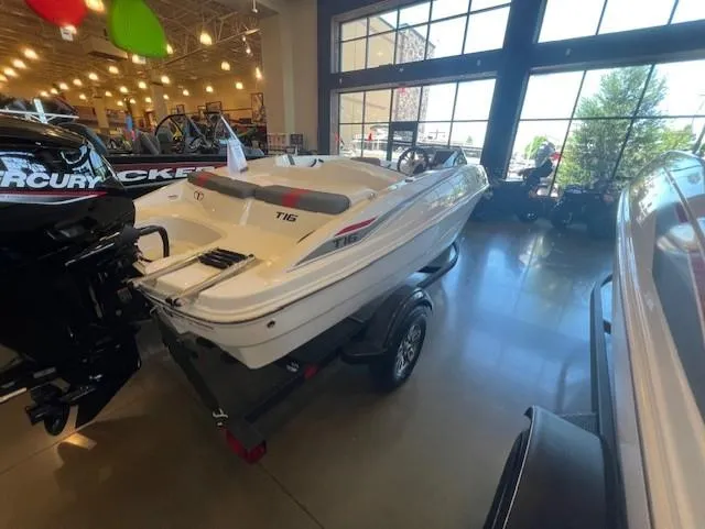 Slide: The Image of 2025 Tahoe T16 boat displayed indoors on a trailer. - 2